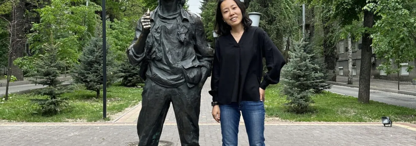 Kim Lacey pictured next to a bronze statue