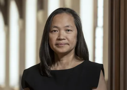 Mary Lui (professor of American Studies and History) at Yale University pictured - she stands with her arms down by her side. She is wearing a black dress with cap sleeves.