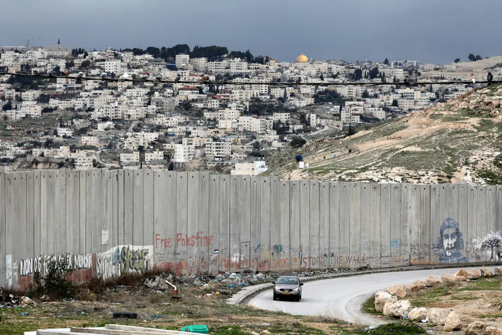 "A view of the wall dividing Jerusalem, in background, from the Palestinian town of Abu Dis in the West Bank. Ammar Awad/Reuters"