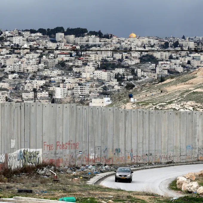 "A view of the wall dividing Jerusalem, in background, from the Palestinian town of Abu Dis in the West Bank. Ammar Awad/Reuters"