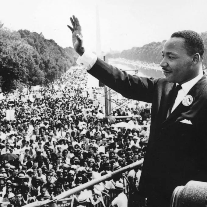 "Martin Luther King waves to the crowd during the historic March on Washington for Jobs and Freedom."